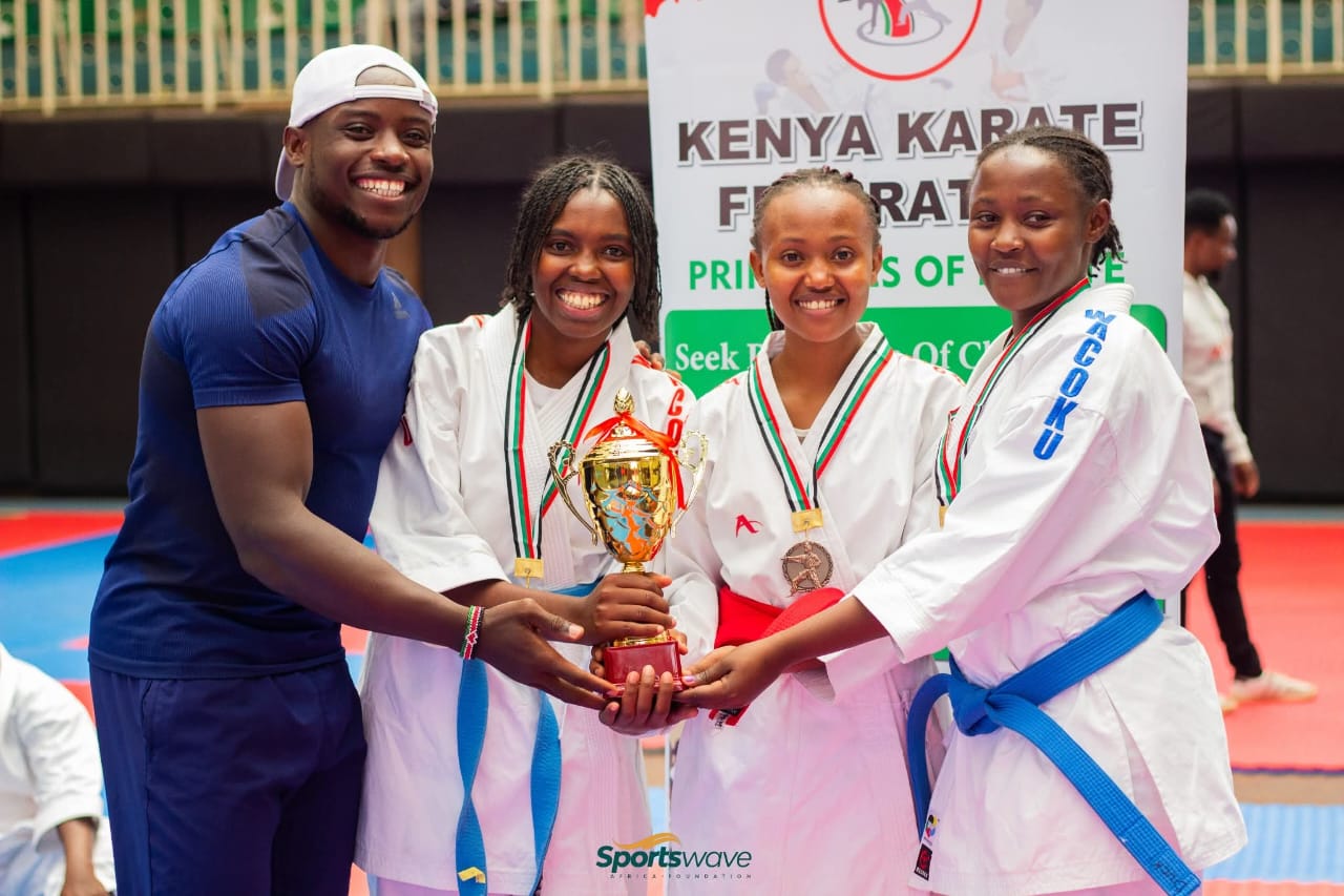 Female team kata winners pose with Africa’s fastest man, Ferdinand Omanyala.